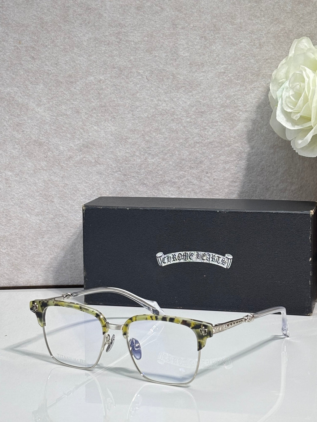 Front view metal eyeglasses with clear lenses, gold accents, and curved frames