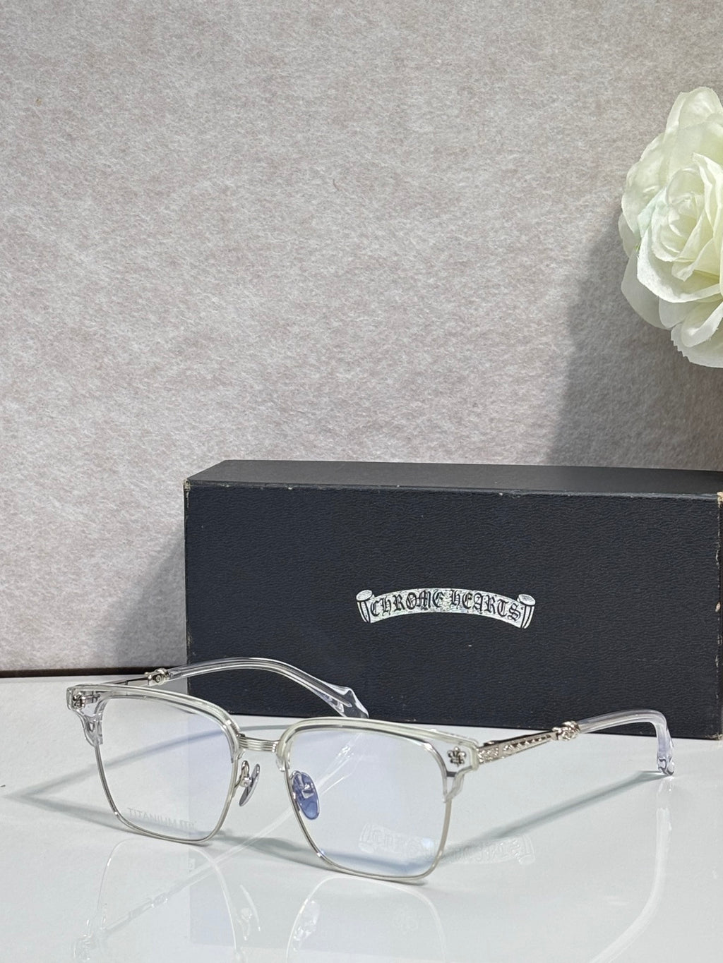 Metal eyeglasses with clear lenses, arched bridge, and gold-toned temples