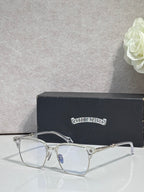 Metal eyeglasses with clear lenses, arched bridge, and gold-toned temples