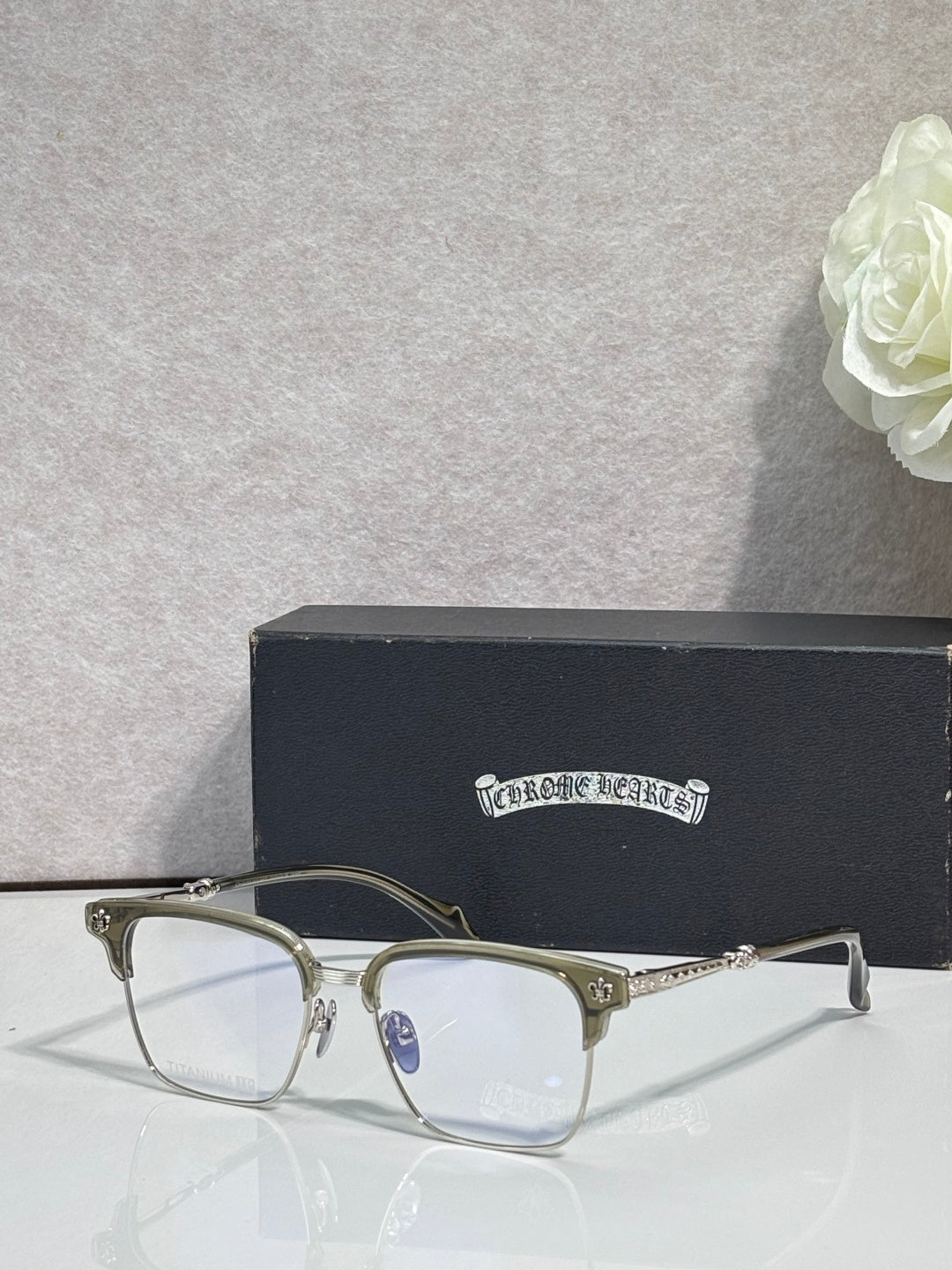 Metal eyeglasses with clear lenses, gold arms, and silver frame front