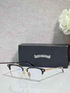 Metal eyeglasses with clear lenses, gold arms, and dark temple tips