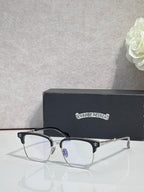 Metal eyeglasses with clear lenses and gold-toned frame details