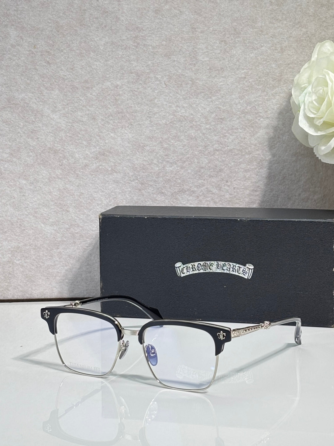 Metal eyeglasses with clear lenses and gold-toned frame details