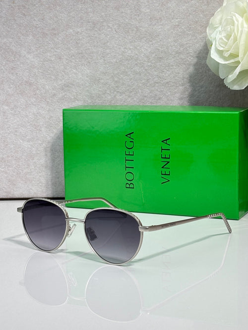 Bottega Veneta round metal sunglasses with very dark lenses and silver-tone frame