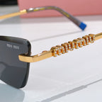 Close-up of jeweled chain-style temple on sunglasses with dark lens and gold frame