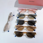 Assorted sunglasses with jeweled chain-style temples and tinted lenses, stacked together