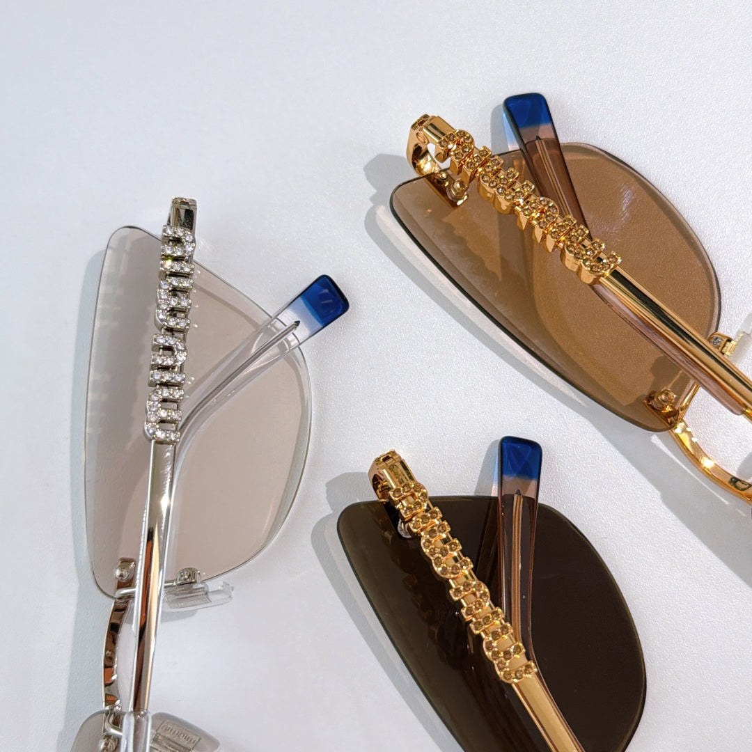 Two pairs of sunglasses: clear-lens silver frame and amber-lens gold frame