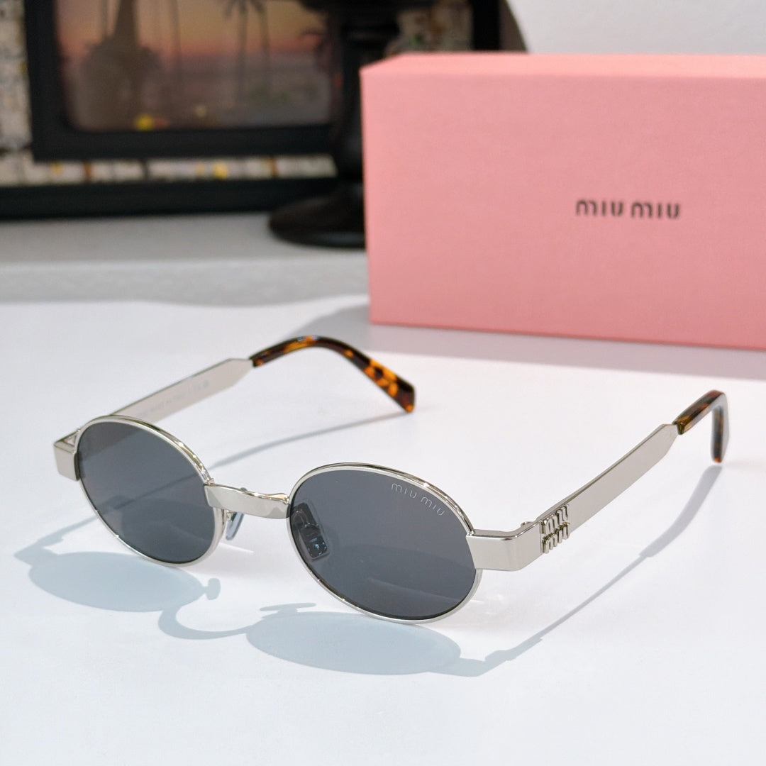 MiuMiu round sunglasses with silver frames, dark lenses, and tortoiseshell temple tips