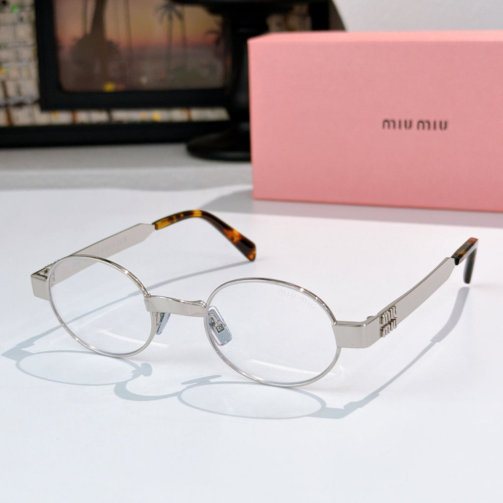 MiuMiu round eyeglasses with silver metal frames, clear lenses, and tortoiseshell temple tips