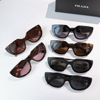 Prada sunglasses assortment: black and tortoiseshell cat-eye frames, dark lenses