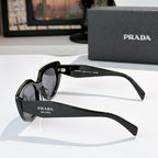 Prada cat-eye sunglasses, black frame with dark lenses, temple logo