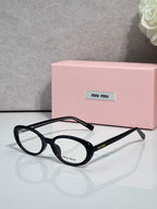 Eyeglasses with dark tortoiseshell round frames and clear lenses, side logo.