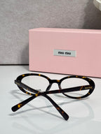 Eyeglasses with dark tortoiseshell round frames and clear lenses, front view.