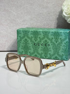 Gucci sunglasses with tan frame, light lenses, and gold horsebit detail