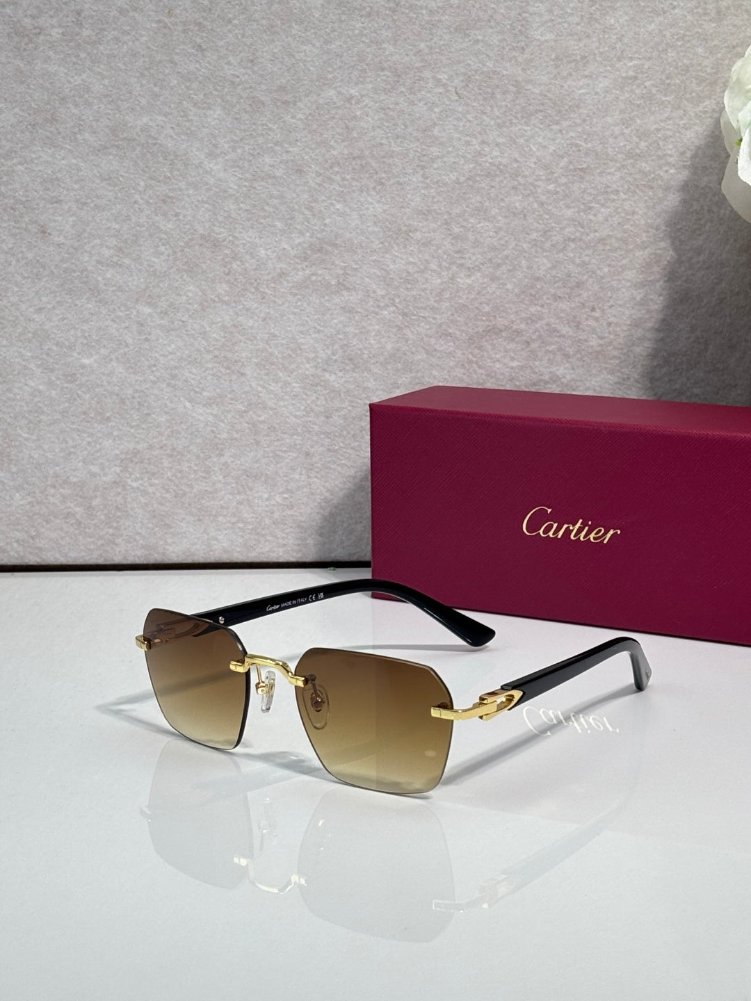 Cartier sunglasses with amber-brown lenses and gold-tone frame with dark arms