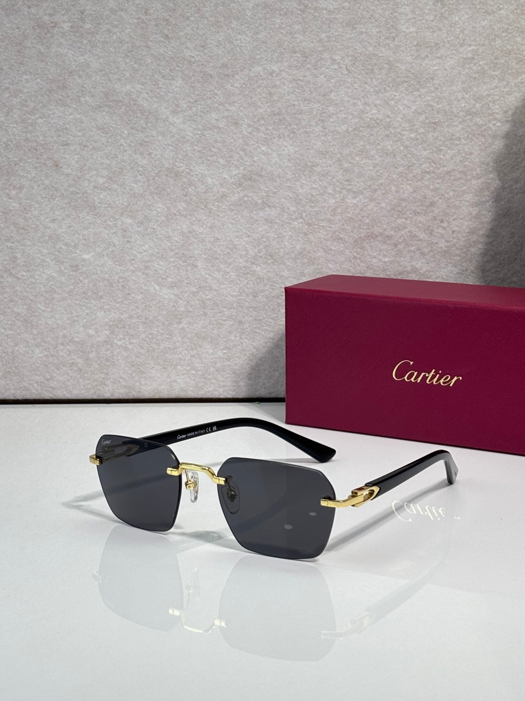 Cartier sunglasses with dark lenses and black frame with gold-tone details