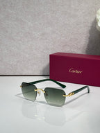 Cartier sunglasses with green-tinted lenses, clear frame arms, and gold-tone details