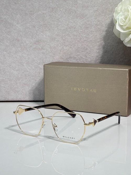 Gold metal round eyeglasses with clear lenses and dark tortoise temple tips, logo.