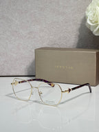 Gold metal round eyeglasses with clear lenses and dark tortoise temples, logo details.
