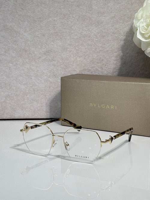 Eyeglasses with clear lenses and gold-tone metal frame, tortoiseshell temples detail.