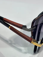 Cartier sunglasses close-up of brown textured temple with gold hinge and dark frame
