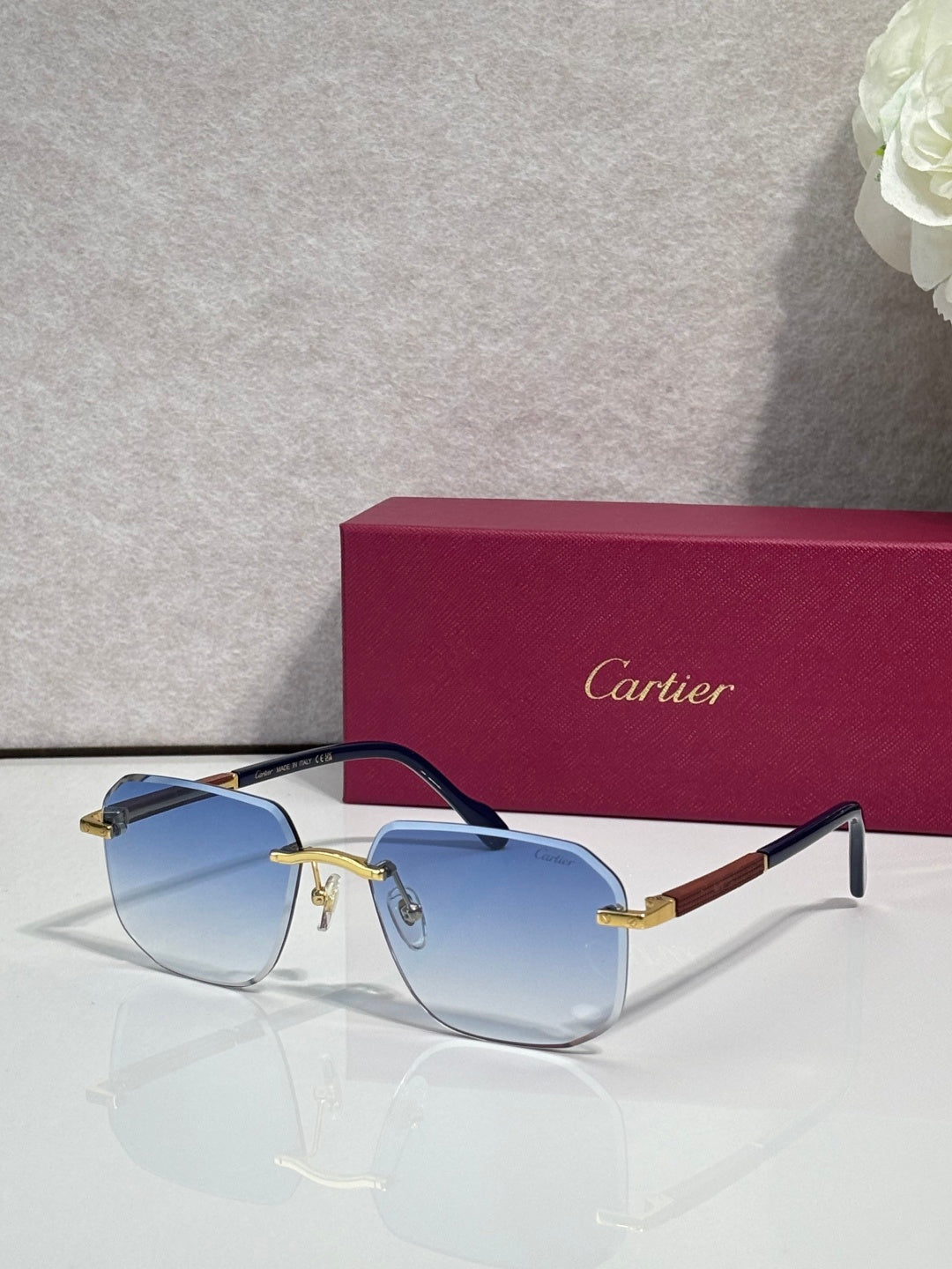 Cartier eyeglasses with dark frames and blue-tinted lenses, gold-tone hinge details