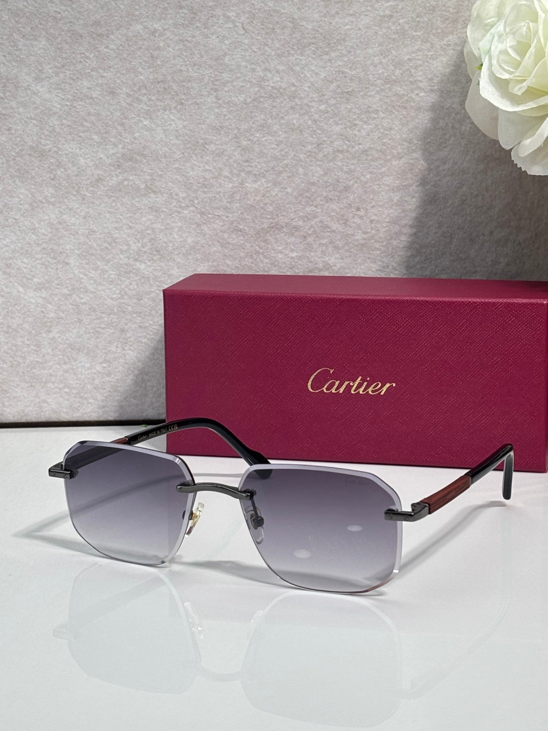 Cartier eyeglasses with dark frames and gray-tinted lenses, gold-tone arms and hinges