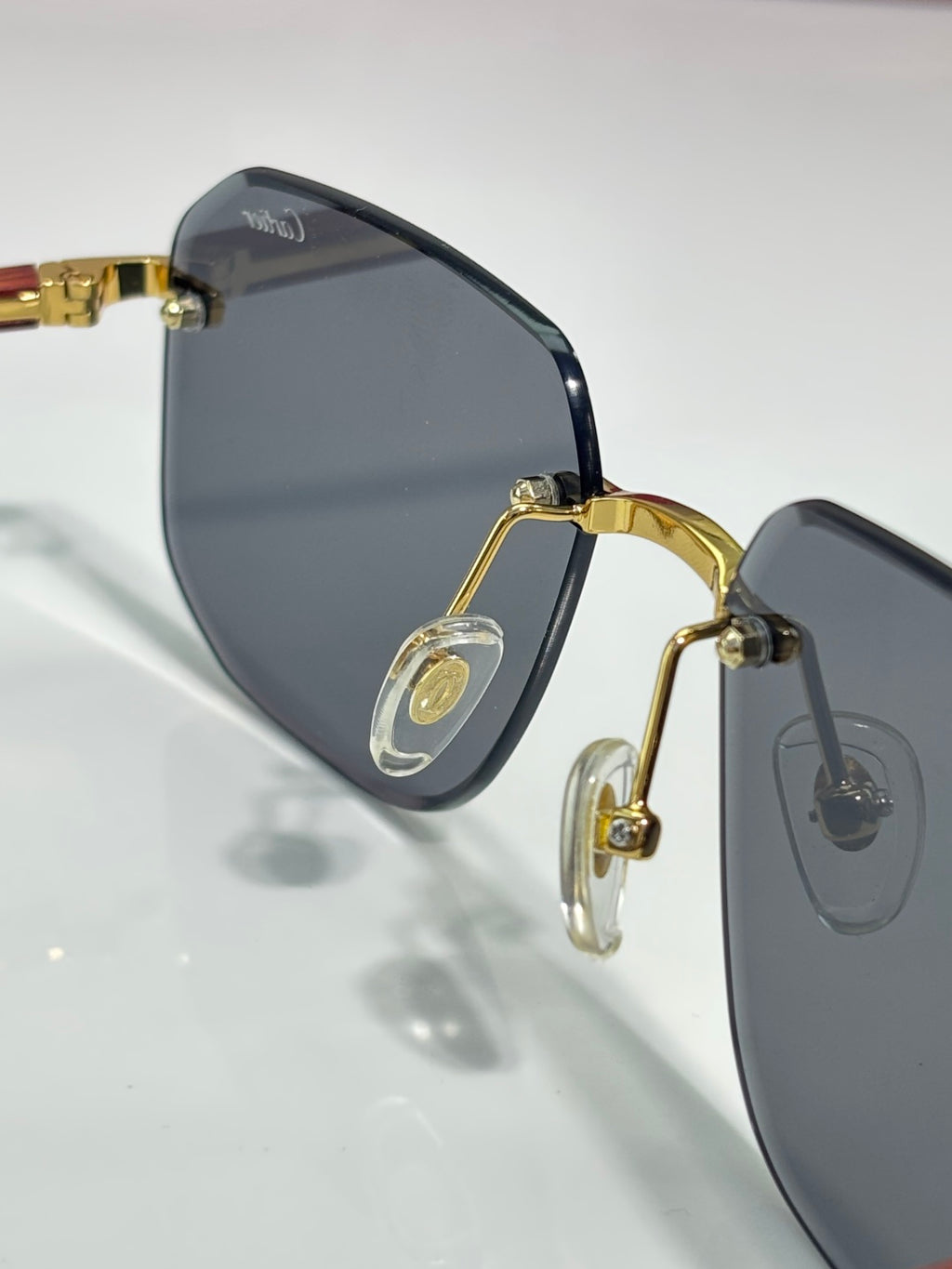 Cartier eyeglasses close-up: dark lenses with gold-tone frame hardware and hinges