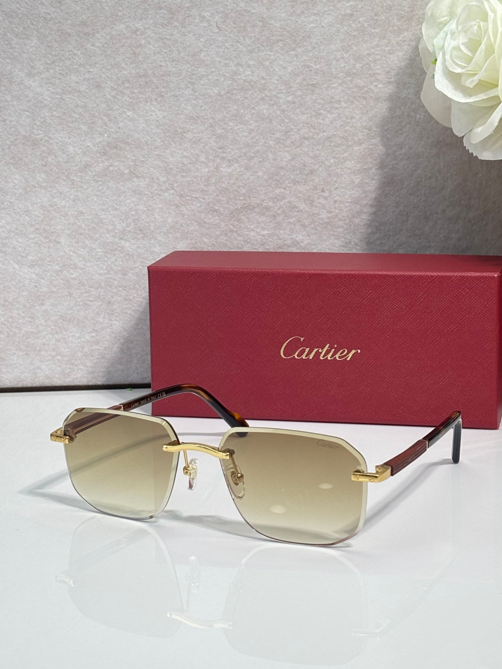 Cartier eyeglasses with dark frames and pale yellow lenses, gold-tone accents