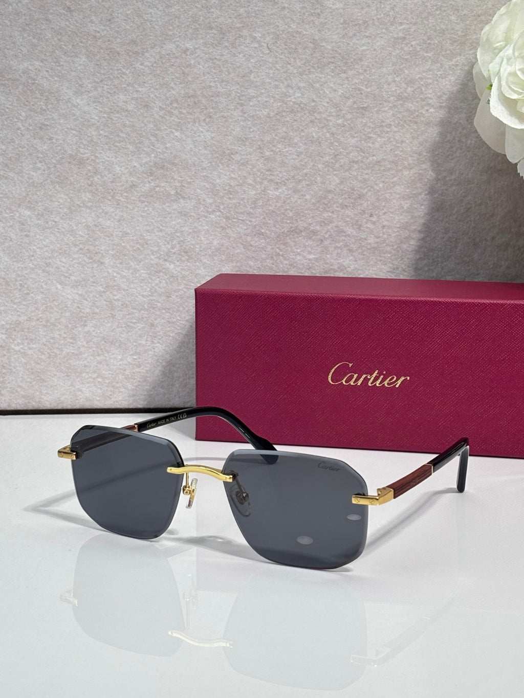 Cartier eyeglasses with dark frames and dark gray lenses, gold-tone bridge accents