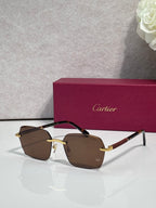 Cartier sunglasses with brown-tinted lenses, dark frame, and gold metal accents.