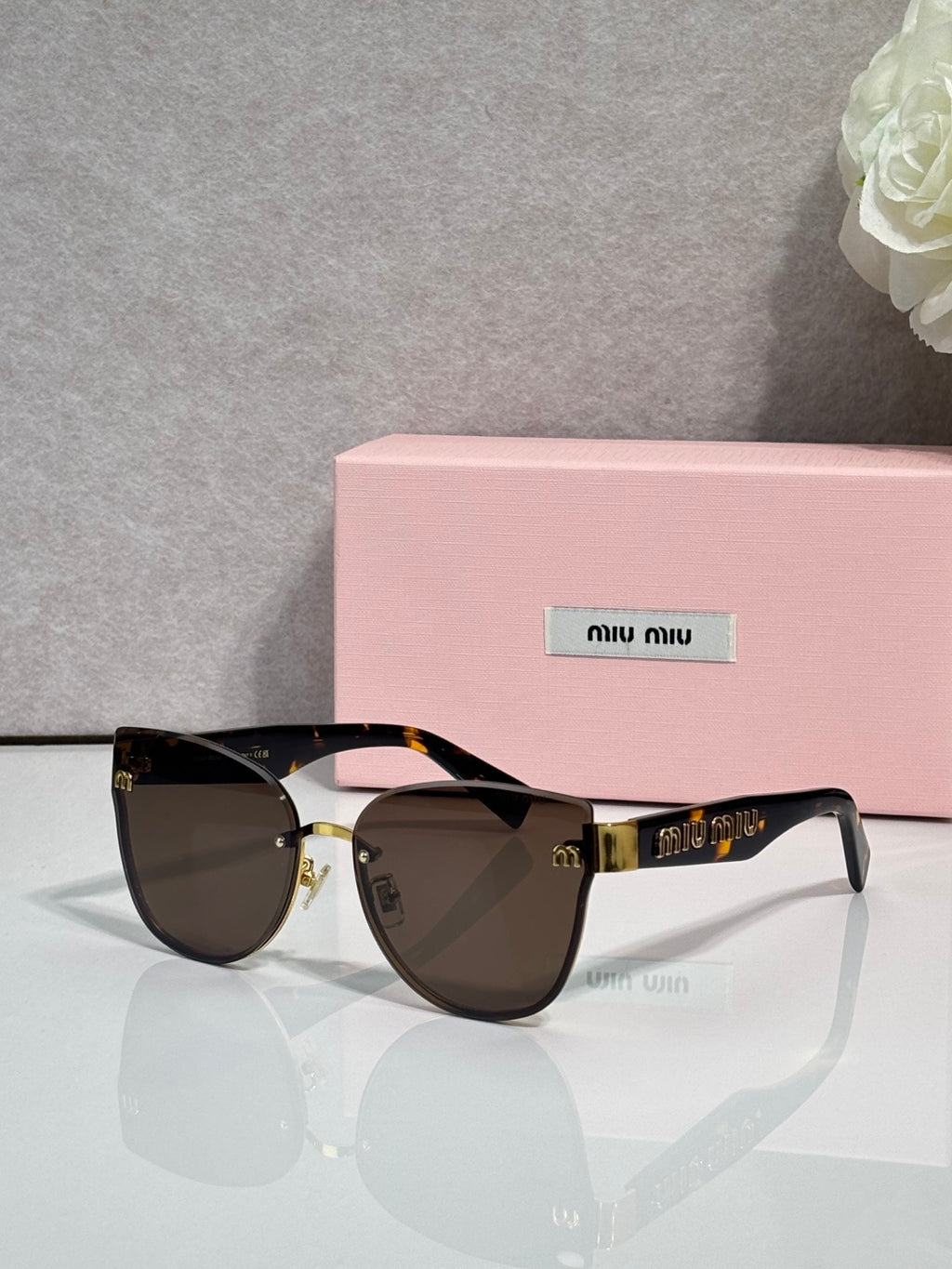 Black round glasses with dark gradient lenses and gold-tone hinges, tortoise-style arms
