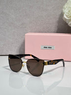 Black round glasses with dark gradient lenses and gold-tone hinges, tortoise-style arms