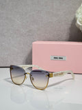 MiuMiu glasses with round tortoiseshell frames and gradient brown lenses, gold accents