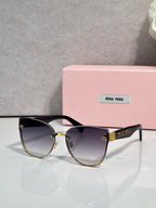 Round black glasses with dark gradient lenses and gold-tone metal hinge accents