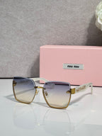 MiuMiu cat-eye sunglasses with pale gradient lenses and gold-tone metal frame