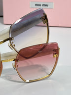 MiuMiu cat-eye sunglasses with burgundy tinted lenses and gold-tone metal hinges