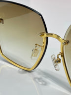 MiuMiu cat-eye sunglasses close-up of gold-tone frame and clear tinted lenses