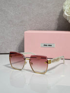 MiuMiu cat-eye sunglasses with rose-tinted lenses and gold-tone metal frame