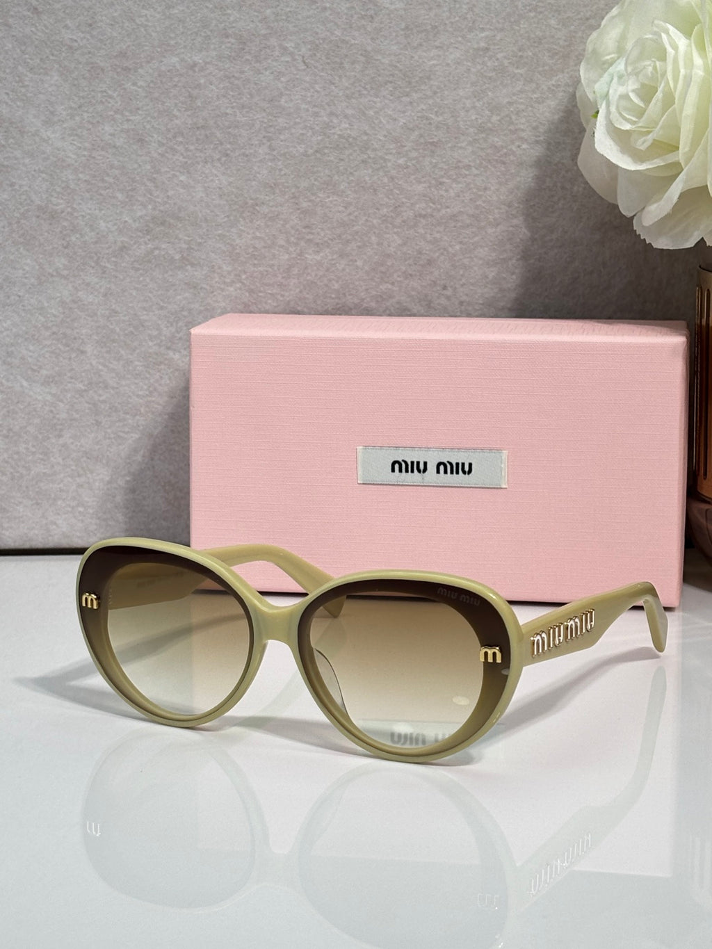 MiuMiu olive round sunglasses with gold logo temples and light yellow lenses