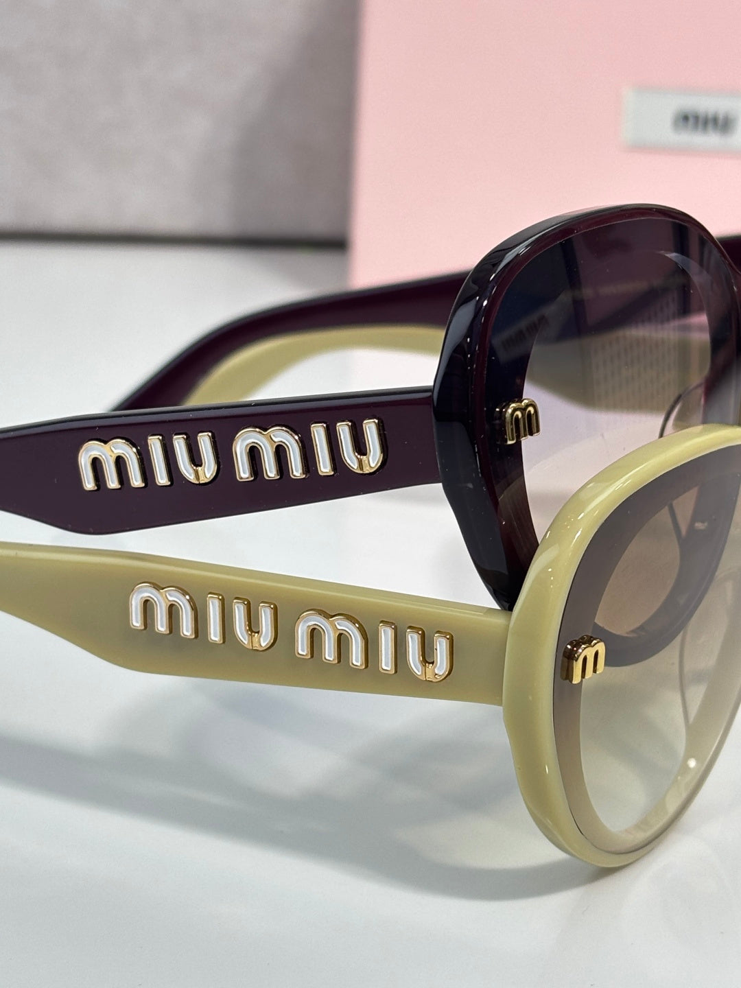 MiuMiu burgundy round sunglasses with lime green arms and gold logo