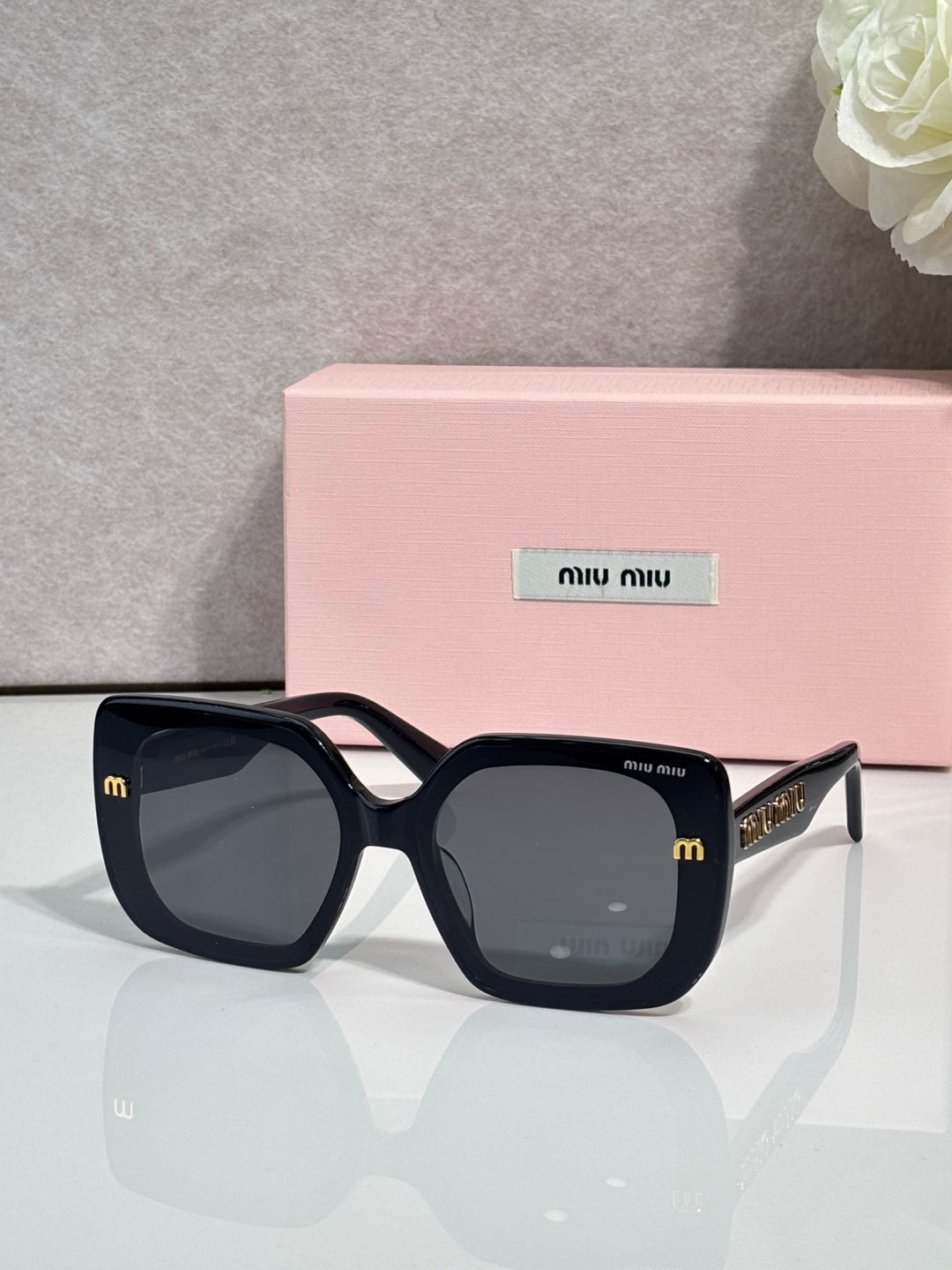 Square sunglasses with dark frames and dark lenses