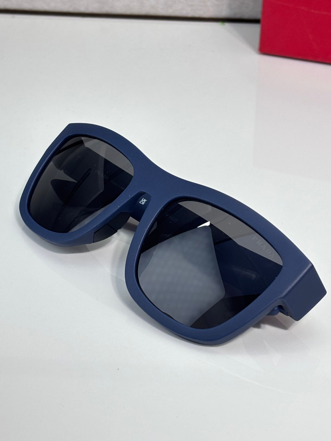 Prada sunglasses close-up with dark navy frames and dark tinted lenses