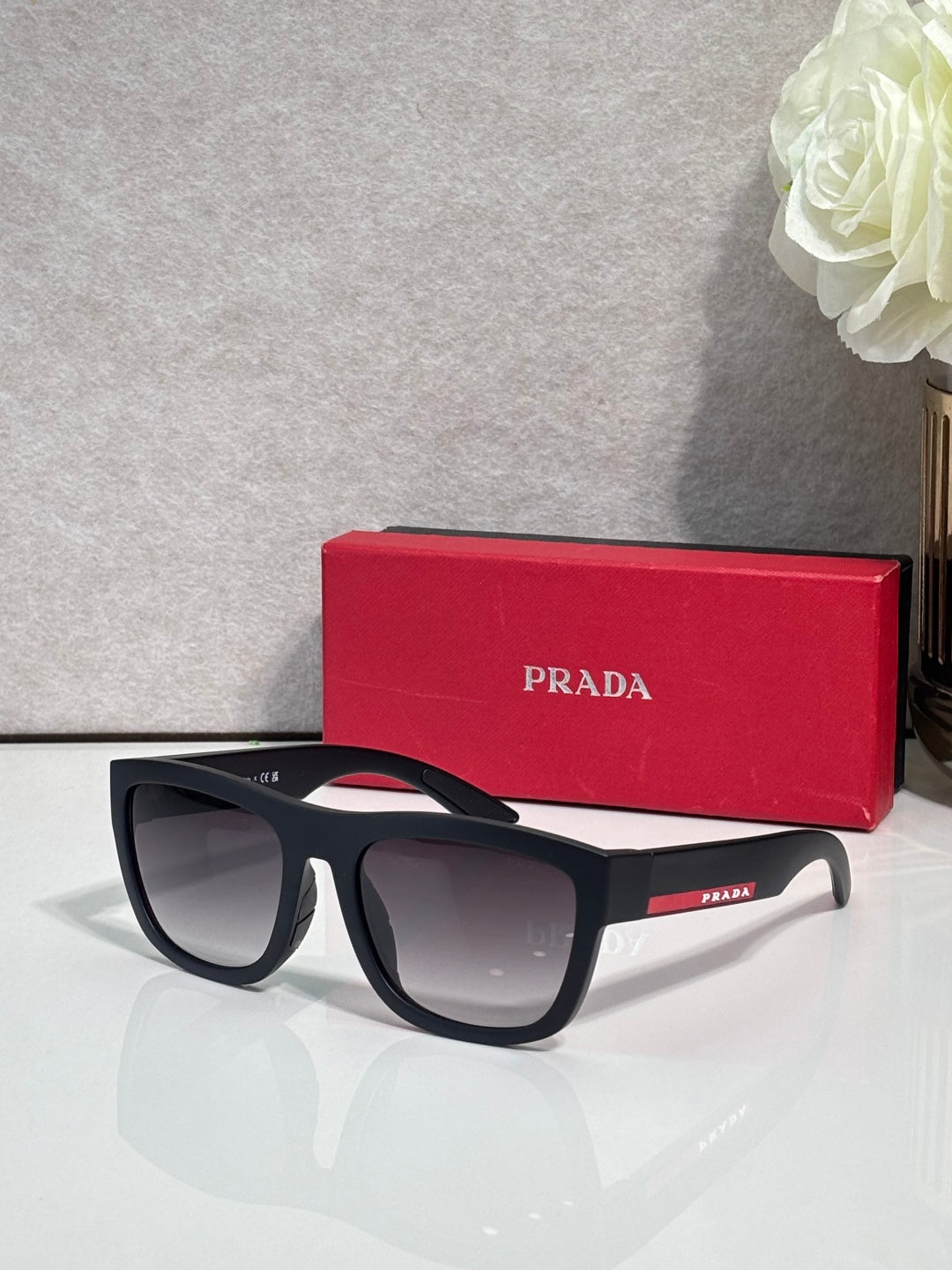 Prada sunglasses with black frames and dark gray lenses