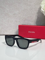Prada sunglasses with matte black frames and dark green-gray lenses