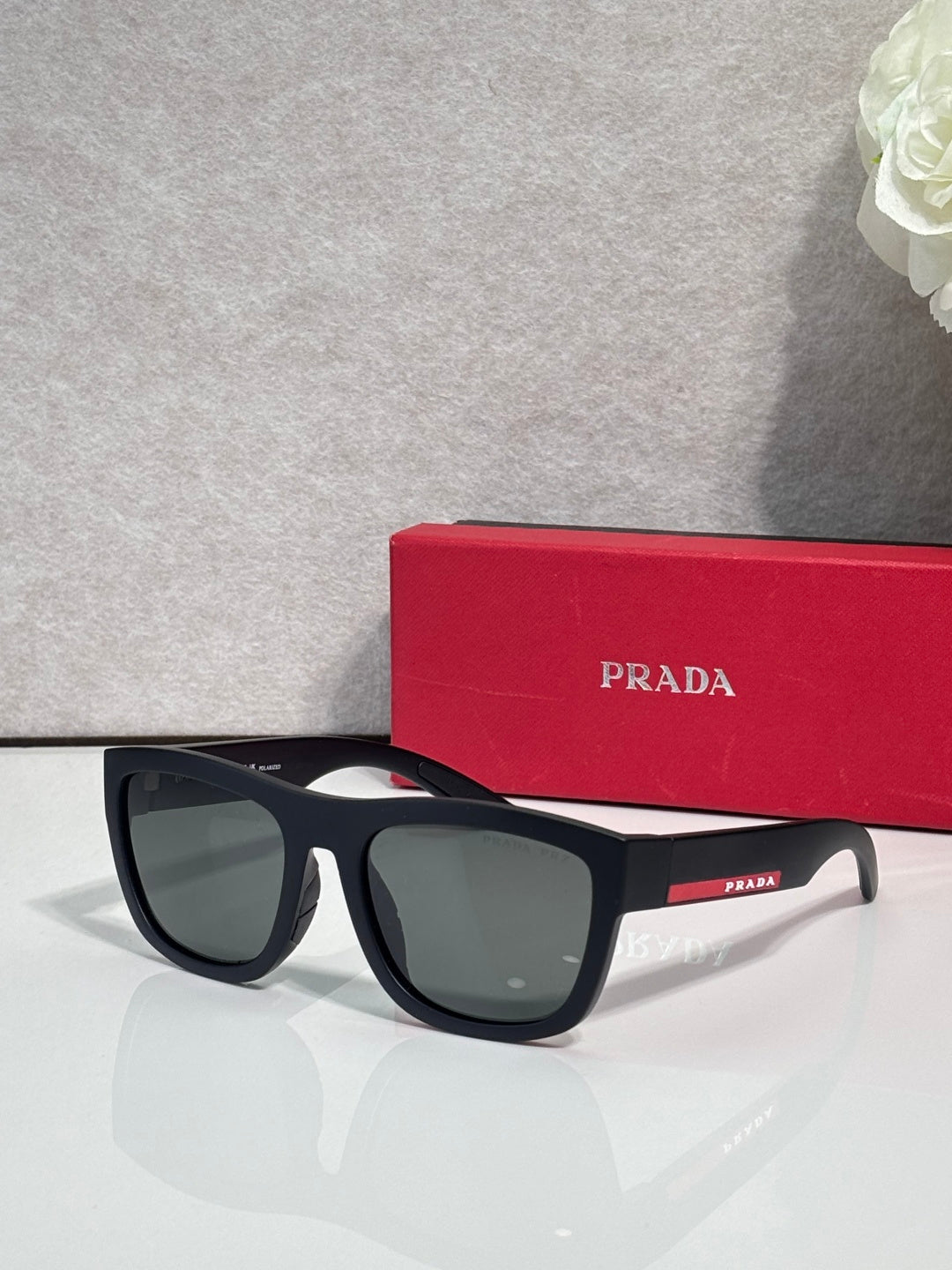 Prada sunglasses with matte black frames and dark green-gray lenses