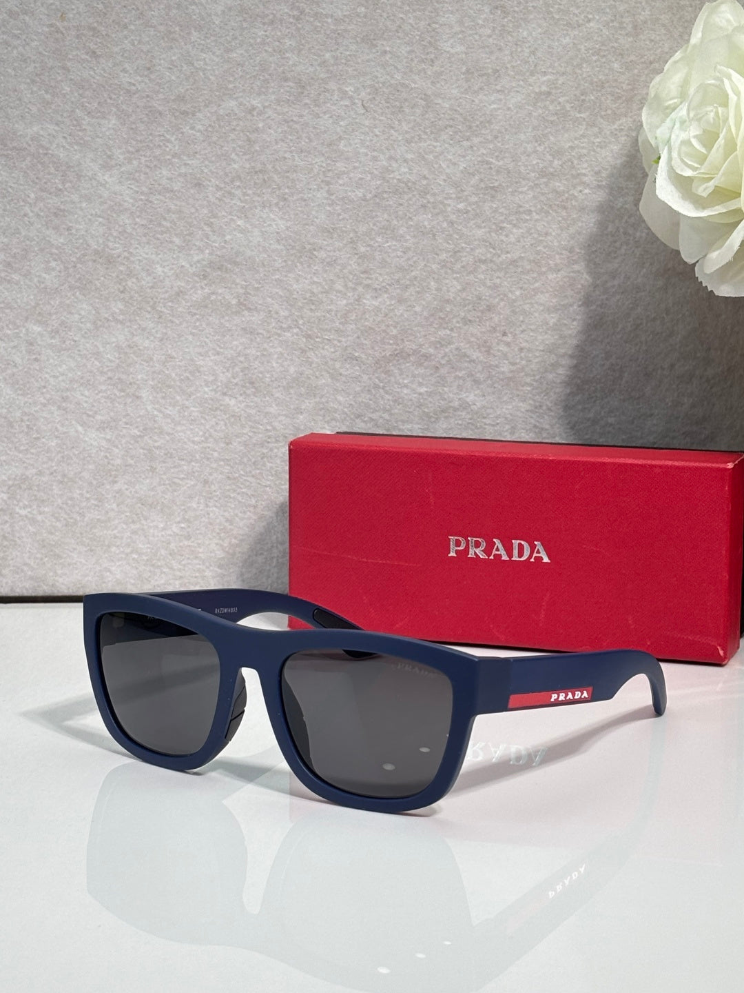 Prada sunglasses with dark navy frames and gray lenses
