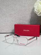 Prada eyeglasses with clear lenses and black rectangular frame, silver bridge and hinges.