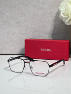 Prada eyeglasses with clear lenses and black rectangular frame, metal temple arms with logo.
