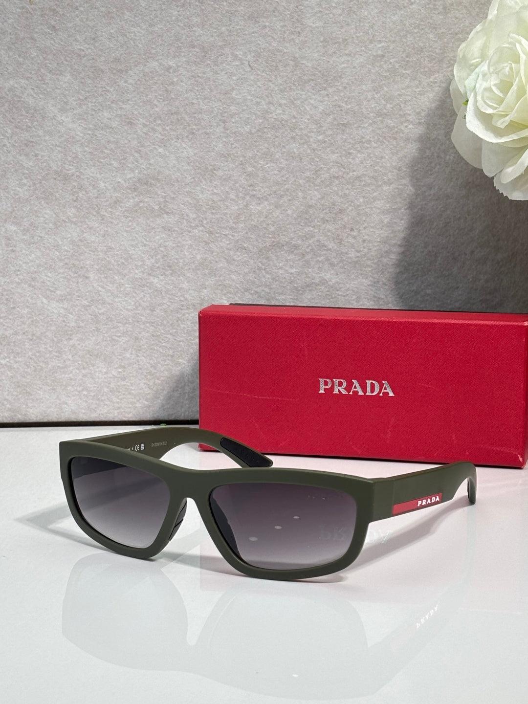 Prada sunglasses with dark frames and dark gray tinted lenses